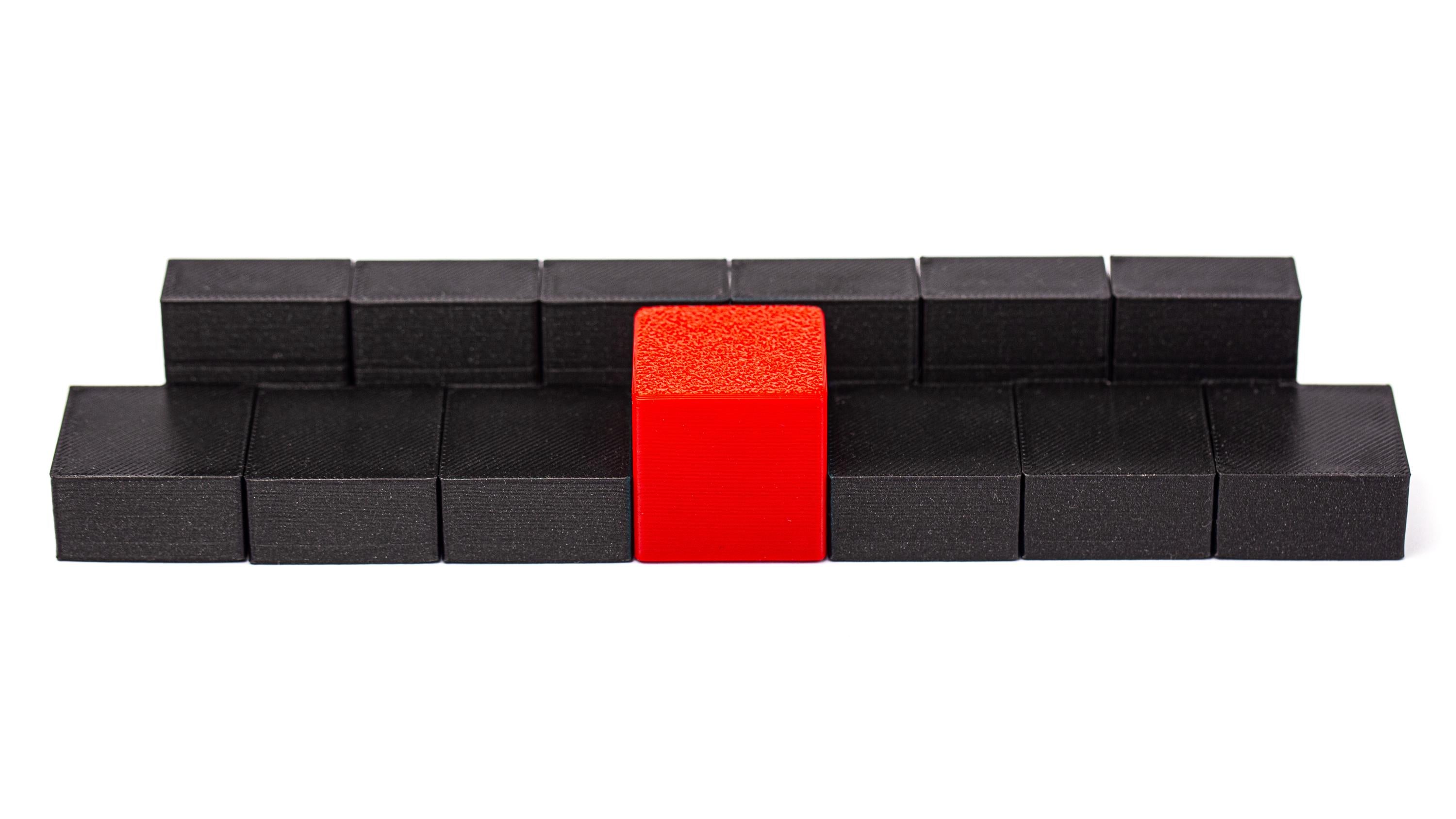 Surround the red cube with 6 black pieces. Surround puzzle.